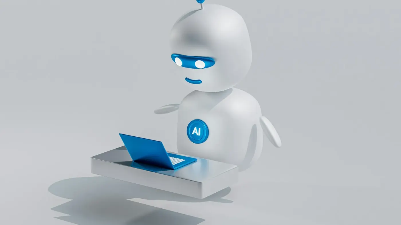 A white robot sitting at a laptop