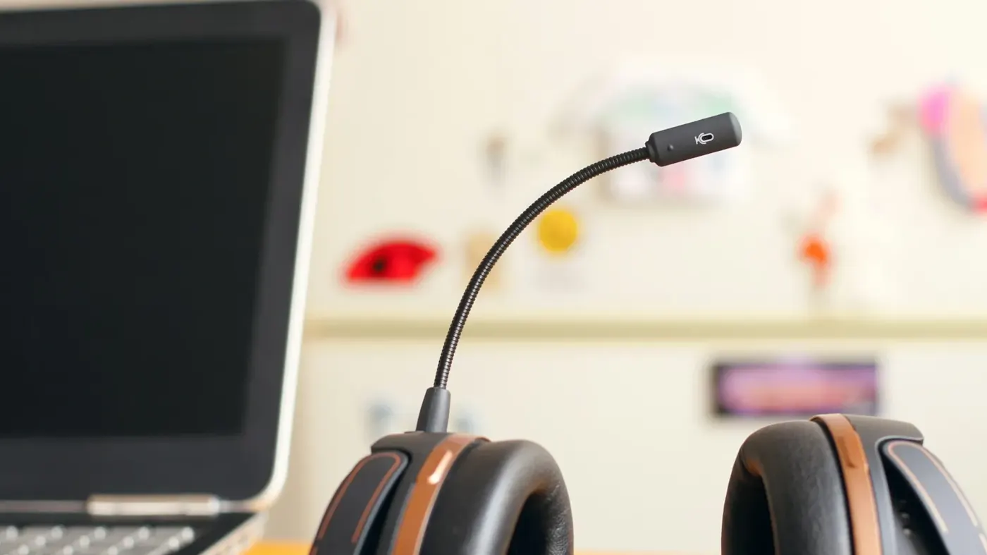 A support headset resting next to a laptop