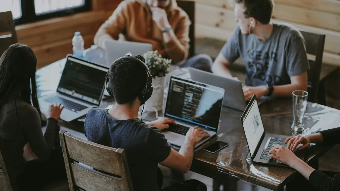 A startup team working together around laptops