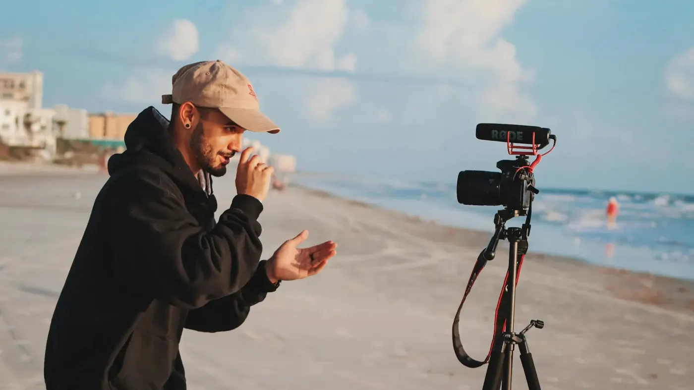 Creator holding a video camera outdoors