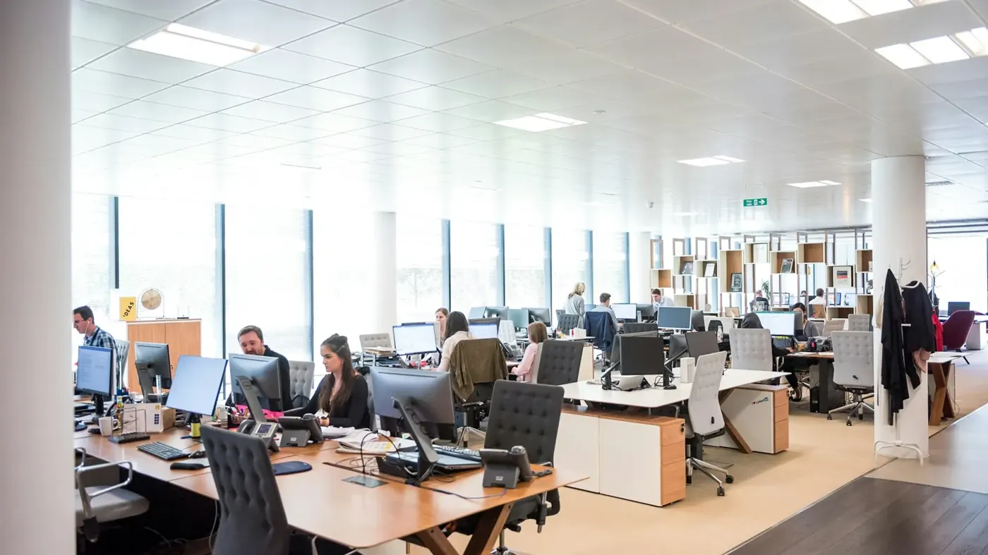 People working at desks in an open office